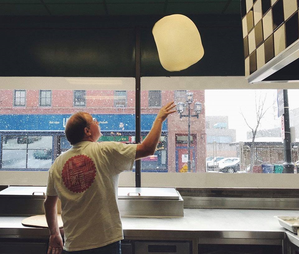 Flipping Pizza Dough in restaurant